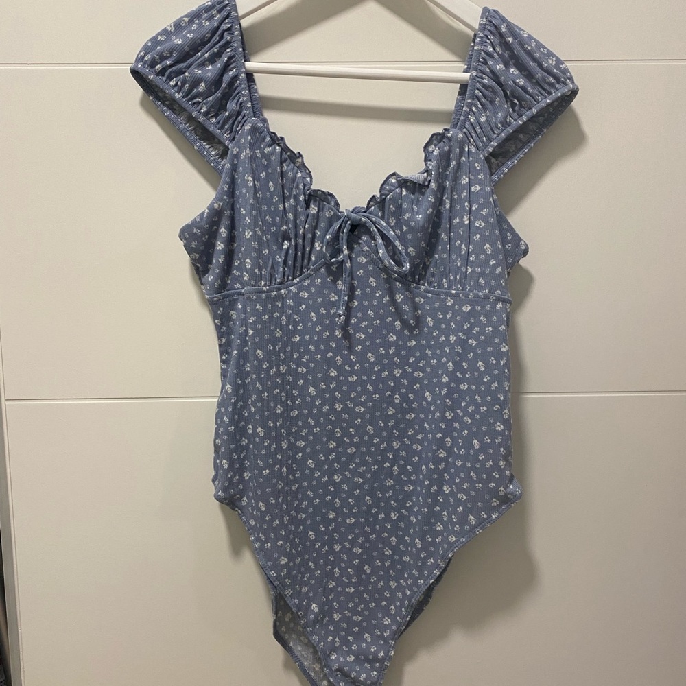 Body suit with front tie detail. Never worn, new with tags.